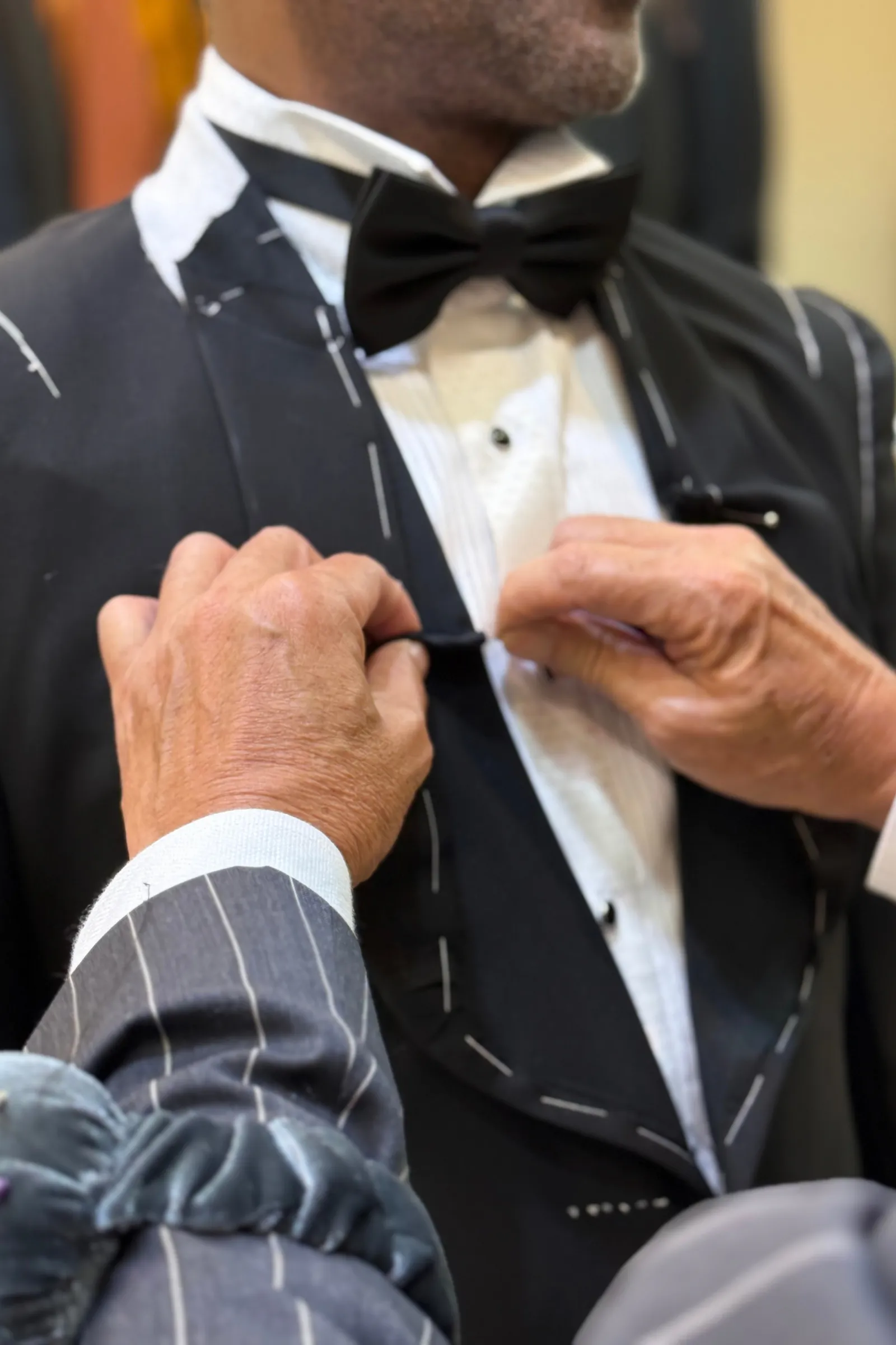 Hand finishing bespoke cloth on the pressing board