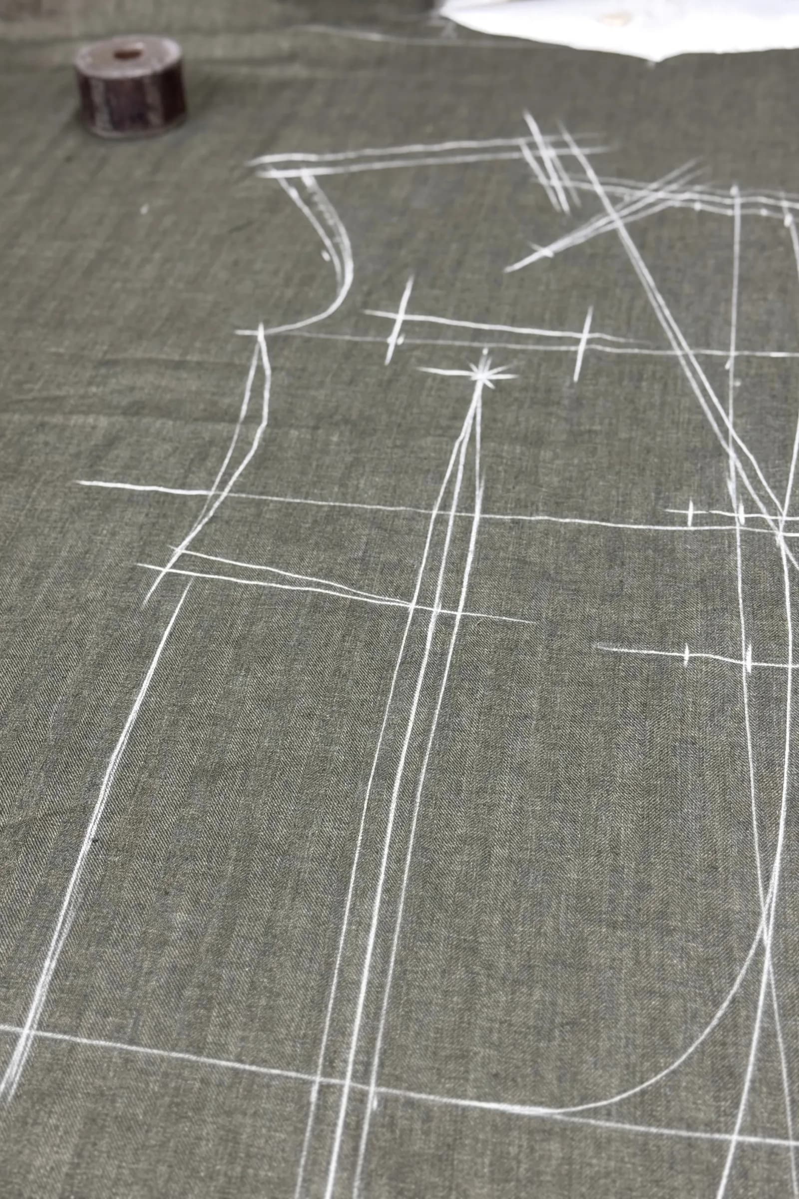 Suiting cloth marked with white tailor's chalk lines before cutting